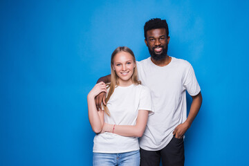 Naklejka premium African American man and beautiful Caucasian woman diverse couple in love, support and care on blue background