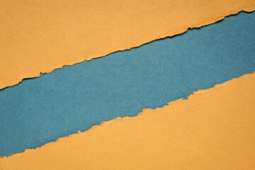 blue and orange paper abstract with a copy space - sheets of bark and cotton rag paper, blank web banner