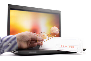 a notebook computer with a colorful display with man holding a a pair of reading glasses on the keyboard isolated on white
