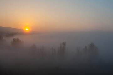 Beautiful foggy autumn sunrise landscape.