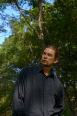 Handsome bearded businessman with long hair at the park
