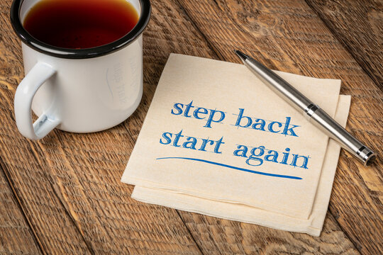 Step Back, Start Again Motivational Note - Handwriting On A Napkin With A Cup Of Tea, Persistence And Determination Concept