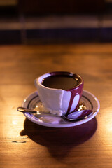 Drinking Chocolate covered with melted milk and white chocolate on a wooden table