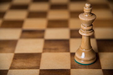 Chess pieces on a wooden board. The concept of tactical games.