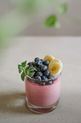 Fototapeta na wymiar Sweet italian panna cotta with blueberry, mint and banana. Fresh tasty breakfast with ripe berries