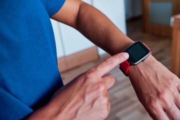 woman arm using smartwatch to control activity indoor