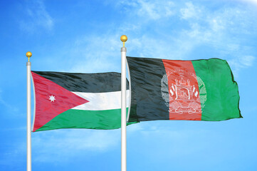 Jordan and Afghanistan  two flags on flagpoles and blue cloudy sky