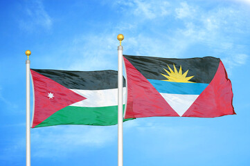 Jordan and Antigua and Barbuda  two flags on flagpoles and blue cloudy sky