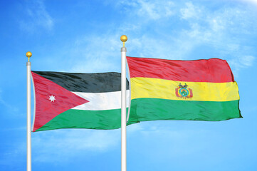 Jordan and Bolivia  two flags on flagpoles and blue cloudy sky