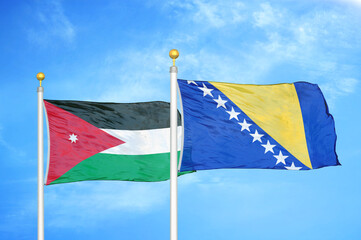 Jordan and Bosnia and Herzegovina  two flags on flagpoles and blue cloudy sky