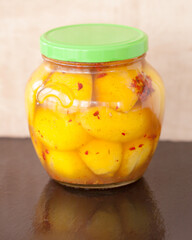 Preserved lemons in glass jar.