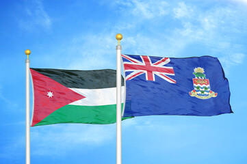 Jordan and Cayman Islands two flags on flagpoles and blue cloudy sky