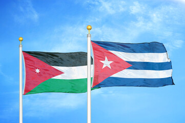 Jordan and Cuba two flags on flagpoles and blue cloudy sky