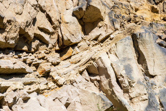 Texture rock surface background. Limestone material wall in nature. Steep slope. Jozefow quarry. Poland, Europe.