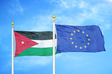 Jordan and European Union two flags on flagpoles and blue cloudy sky