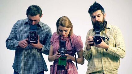 Film camera. Group photographers are proud of their old retro cameras. Photographers conduct a photo session. Photography shooting workshop course. Retro toned.