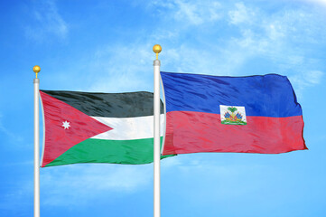 Jordan and Haiti two flags on flagpoles and blue cloudy sky