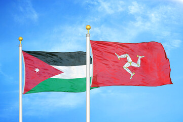 Jordan and Isle of Mann two flags on flagpoles and blue cloudy sky