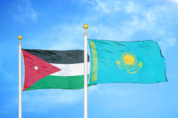 Jordan and Kazakhstan two flags on flagpoles and blue cloudy sky