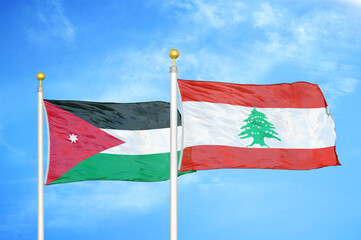 Jordan and Lebanon two flags on flagpoles and blue cloudy sky