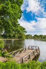 Fototapeta premium Landscape with a lake and a wooden bridge. Samchyky palace. Ukraine