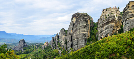 Fototapeta na wymiar Wide panoramic view of the mountain formations of Meteora, Monastery of Varlaam on the right and Holy Monastery of Saint Nicholas Anapafsas at Meteora on the left
