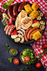 Obraz na płótnie Canvas Grilled sausages, meat, and vegetables.