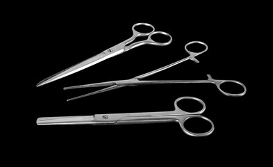 Set of scissors isolated in gray steel black background