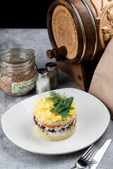 Traditional russian salad dressed herring with boiled egg, beetroot and carrot, flavoured with mayonnaise