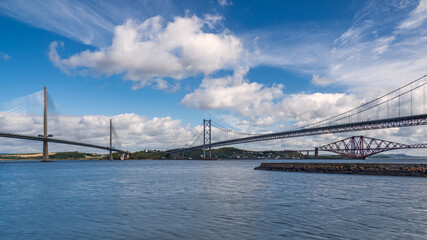 The Forth Bridges near Edinburgh in Scotland. Towering side by side over the Firth of Forth, these structures represent Scottish engineering over three centuries