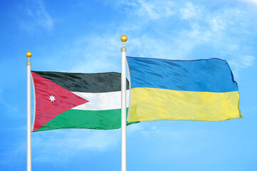 Jordan and Ukraine two flags on flagpoles and blue cloudy sky