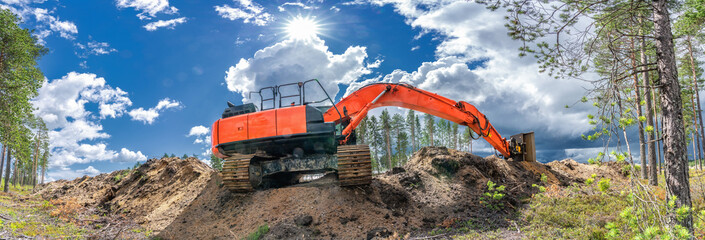 Panorama view on orange excavator that stands on top of digged from trench sand. Fully stretched...