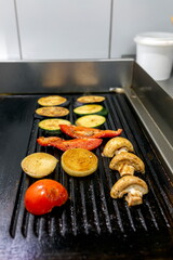 Cooking vegetables grill on the frying surface in black