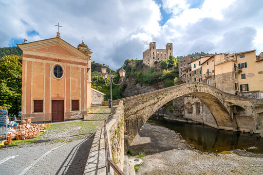 The famous, medieval Monet bridge with the Church of San Filippo next to it in the historic ancient hilltop city of Dolceacqua, Italy.