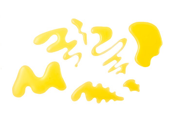 drops and splashes of honey isolated on white background. Top view.