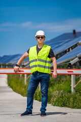 Fototapeta na wymiar Engineer is looking out at new energy base of solar system pannels.