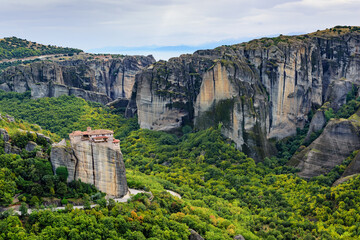 View of the stunning rock formations of Meteora and Holy Monastery of Rousanou. TheMonastery has received the name of the first probable hermit who settled on the rock.
