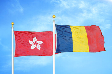 Hong Kong and Chad  two flags on flagpoles and blue cloudy sky