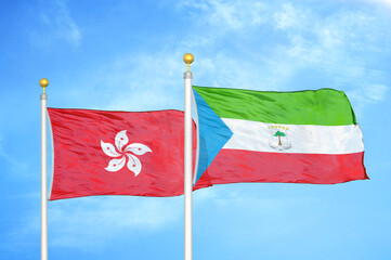 Naklejka na ściany i meble Hong Kong and Equatorial Guinea two flags on flagpoles and blue cloudy sky