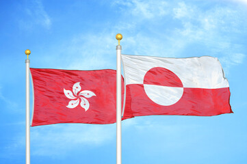 Hong Kong and Greenland two flags on flagpoles and blue cloudy sky