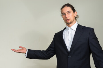 Portrait of handsome bearded businessman with long hair