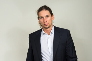 Portrait of handsome bearded businessman with long hair