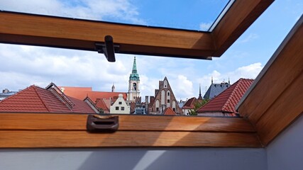 Window view over roofs of historical buildings.