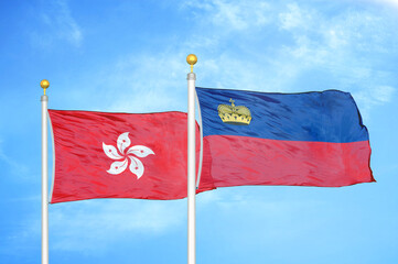 Hong Kong and Liechtenstein two flags on flagpoles and blue cloudy sky