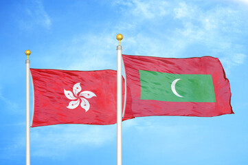 Hong Kong and Maldives two flags on flagpoles and blue cloudy sky