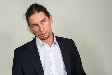 Portrait of handsome bearded businessman with long hair