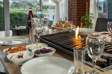 Different types of meat grilled on Barbecue on the table, Served with special Turkish appetizers and Turkish raki