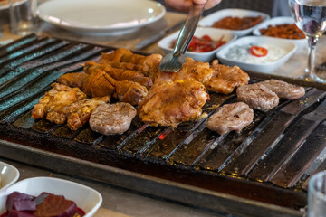 Different types of meat grilled on Barbecue on the table, Served with special Turkish appetizers and Turkish raki