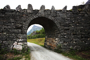 Fototapeta na wymiar A Norwegian bridge over a small road in the countryside, Scandinavia. 