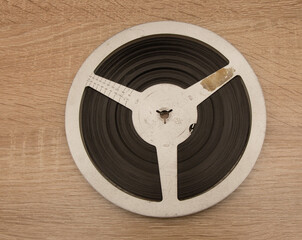 Old 8mm film reel on wooden table